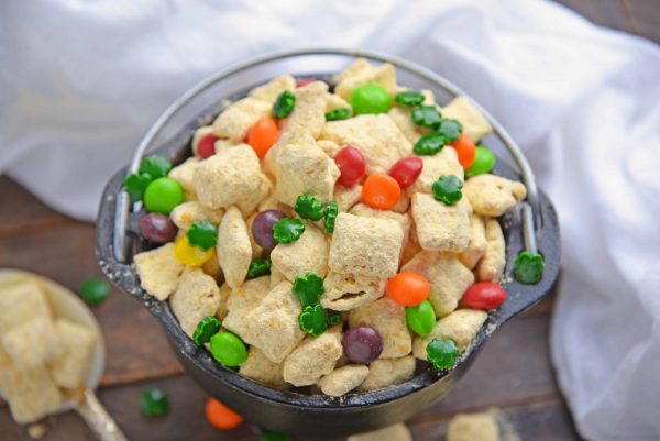 Pot of Gold PUppy Chow is the perfect gold St. Patrick's Day dessert or snack. Easy to make, make-ahead and delicious to eat, it will be the hit of your St. Patrick's Day bash! #puppychowrecipe #stpatricksday #potofgold www.savoryexperiments.com