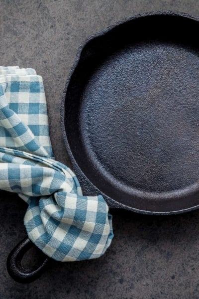 How to clean cast iron cookware in easy steps, plus how to care for and maintain cast iron to make the most of your seasoning and prevent rust! #howtocleancastiron #howtoremoverustfromcastiron www.savoryexperiments.com