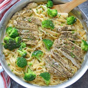 Broccoli chicken Alfredo in a stainless steel skillet