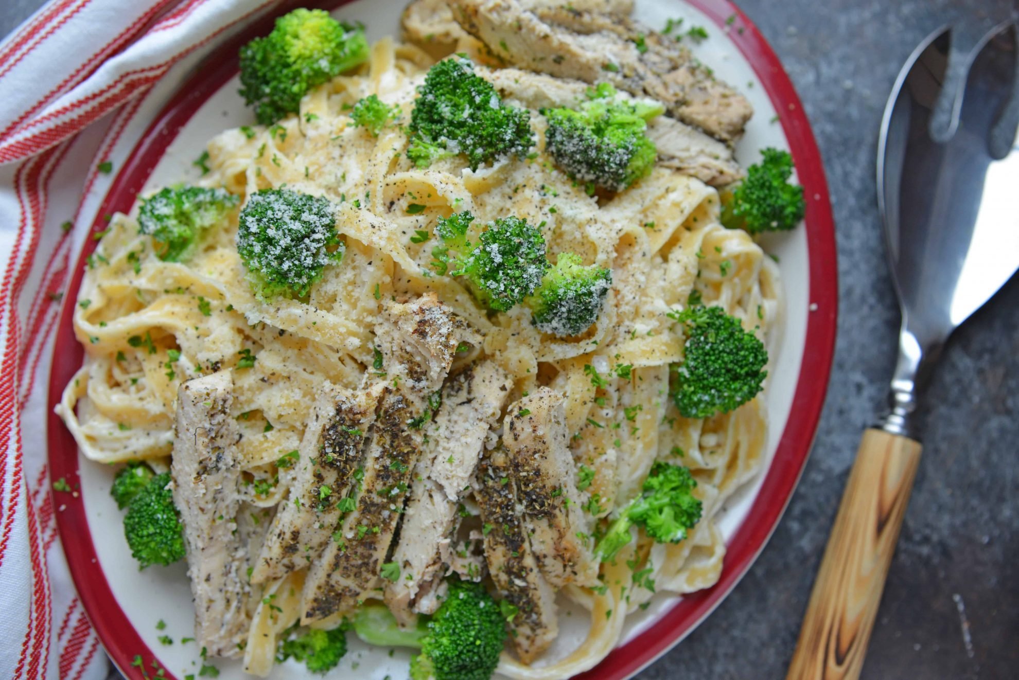 Broccoli Chicken Alfredo on a red and white serving dish