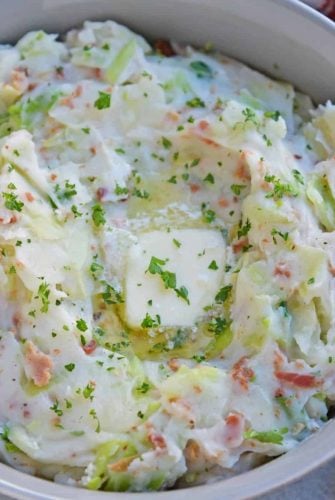 Overhead of colcannon in a bowl and topped with butter