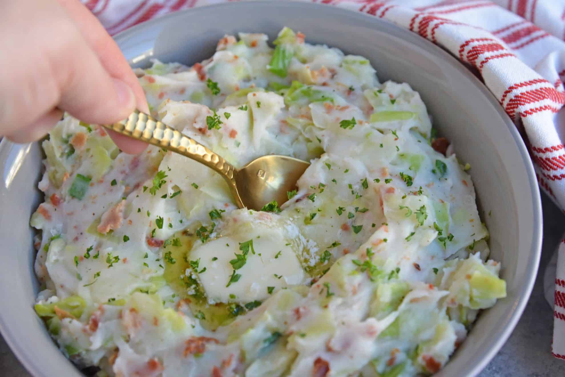 Spoon dipping into Irish Colcannon using cabbage