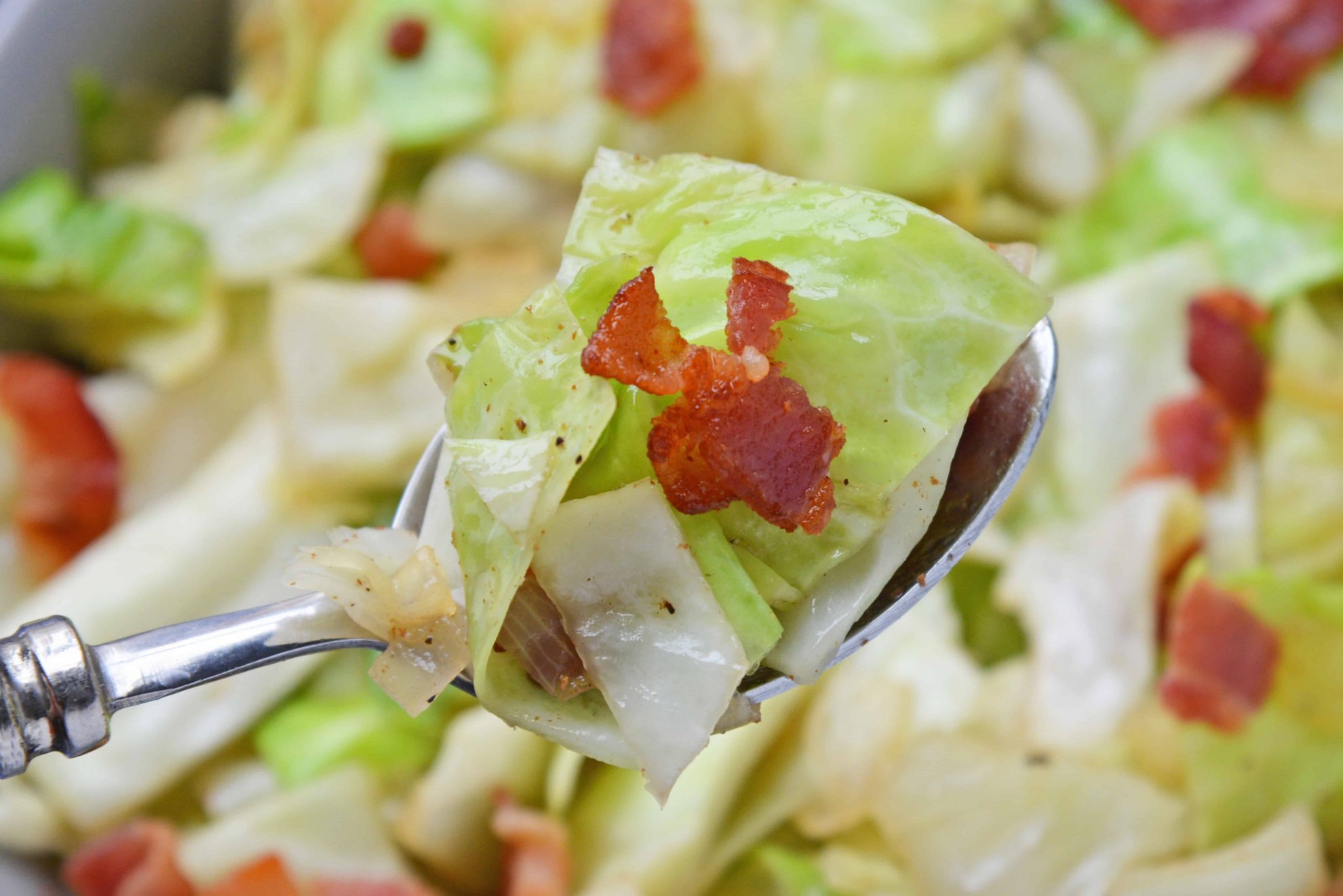 Spoon with Fried Cabbage with Bacon and Onions