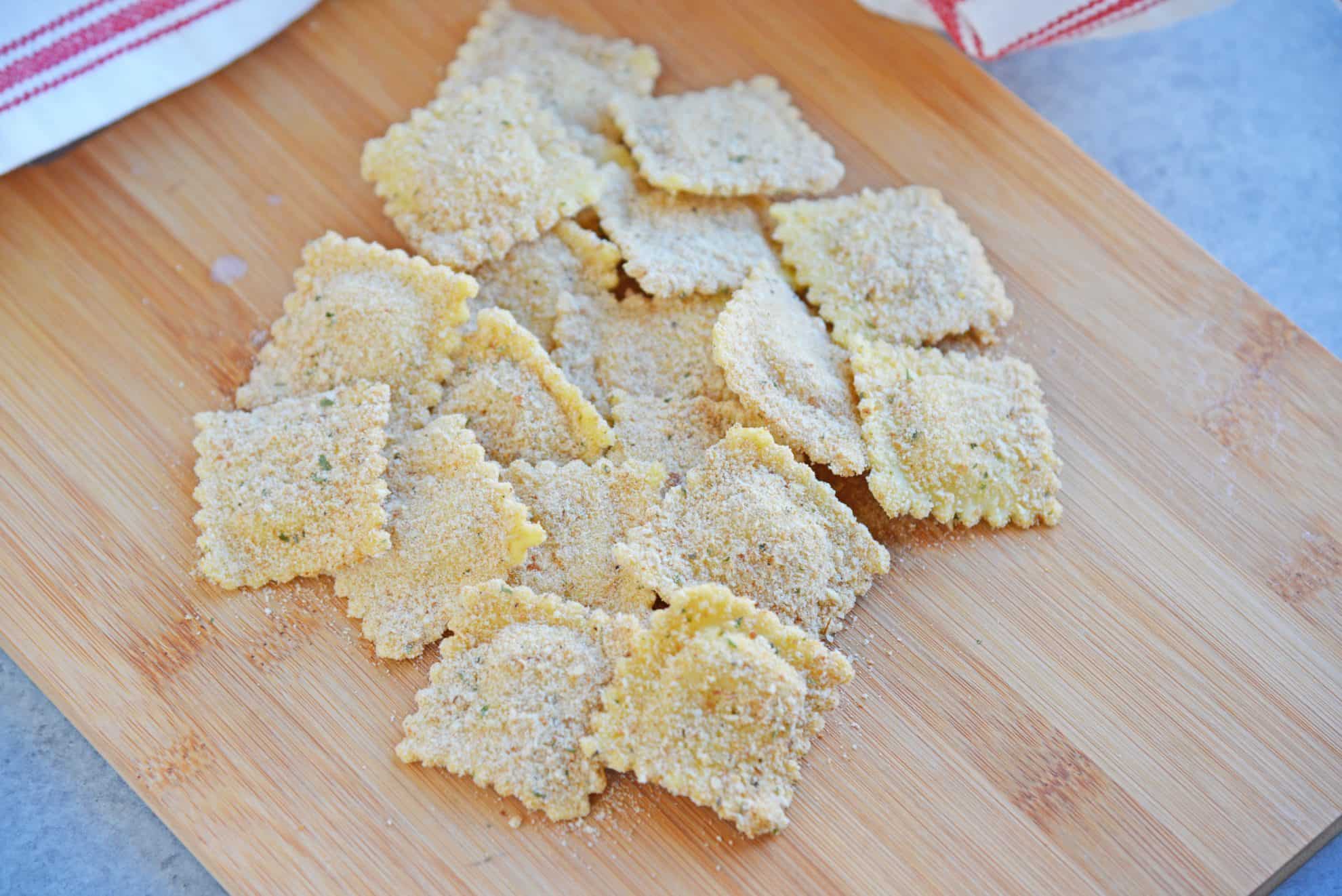 Breaded Ravioli on a wood cutting board