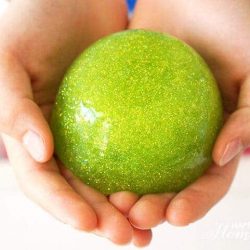 hand holding a green glitter ball