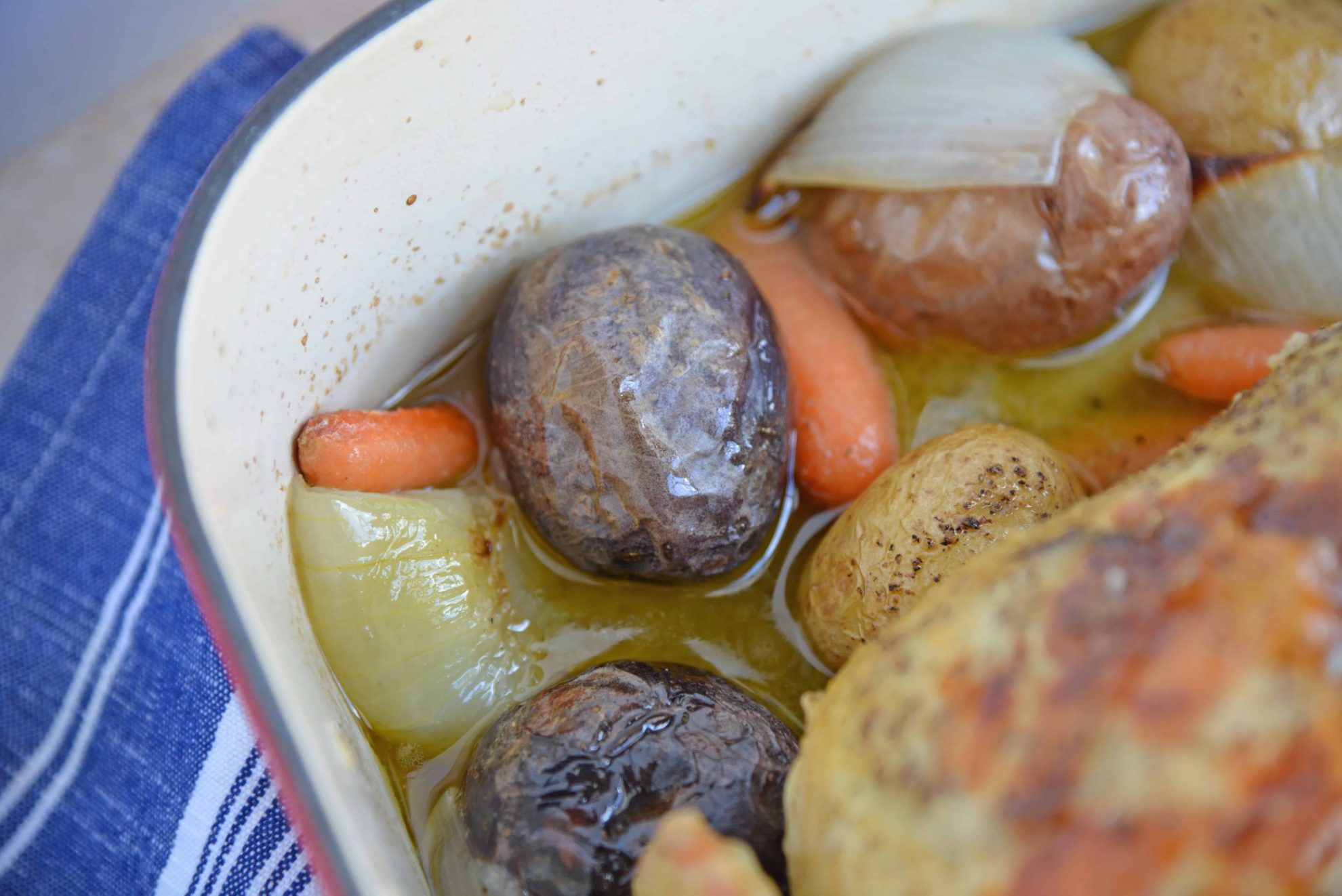 Close up of buttered potatoes in roasting pan