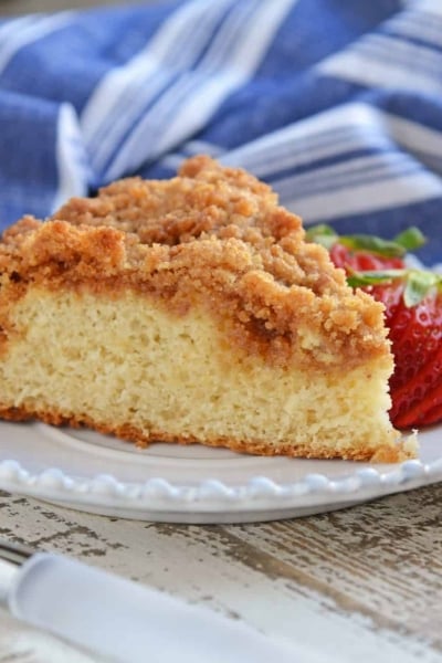 Side view of a coffee cake with sliced strawberries