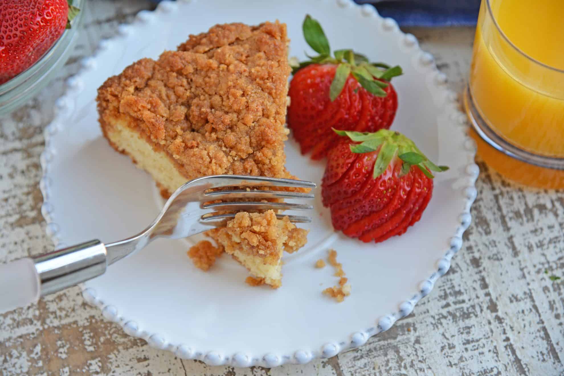 Fork cutting into a slice of coffee cake