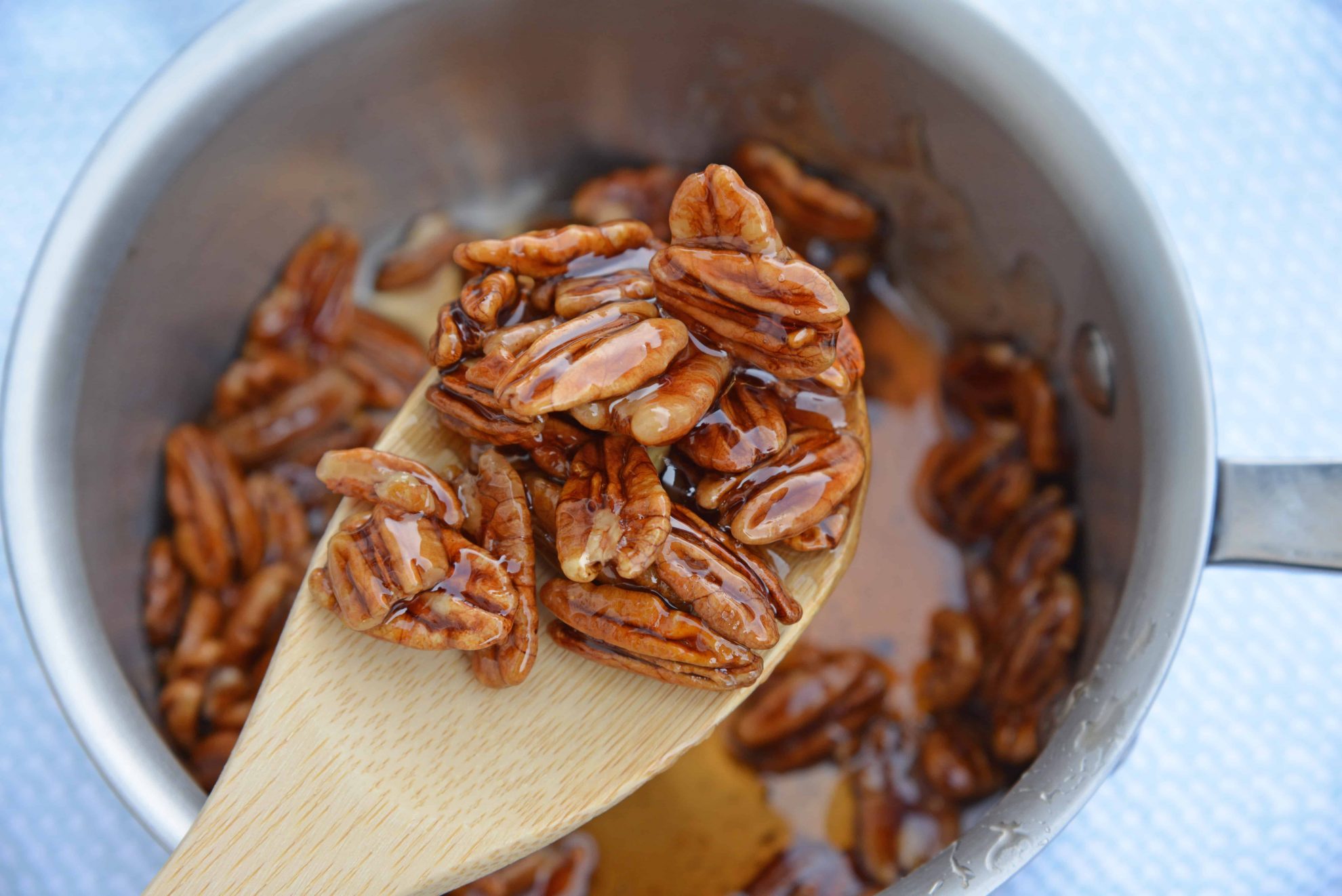 Pecan Caramel Sauce on a wooden spoon