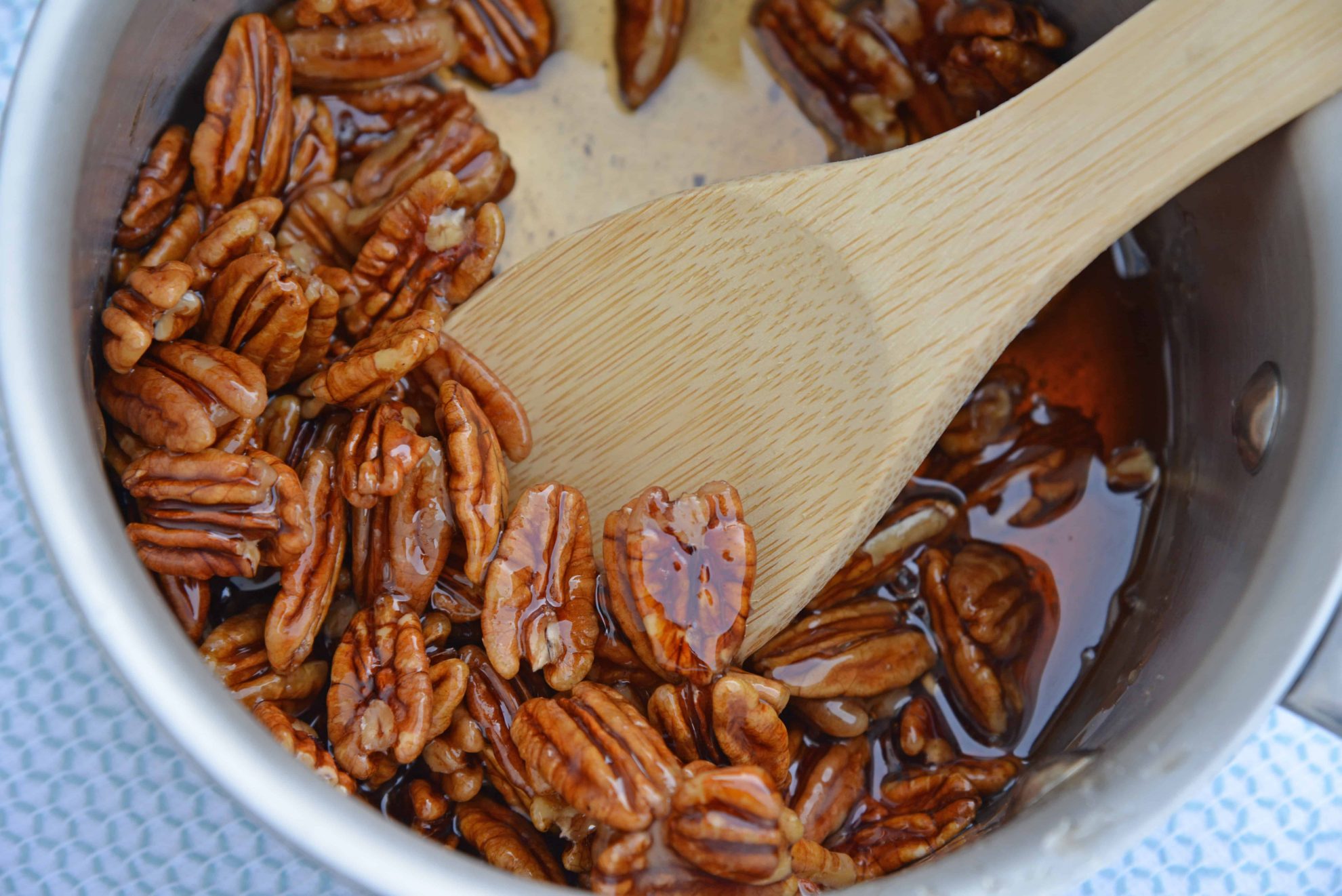 Closeup of Pecan Caramel Sauce with wooden spoon