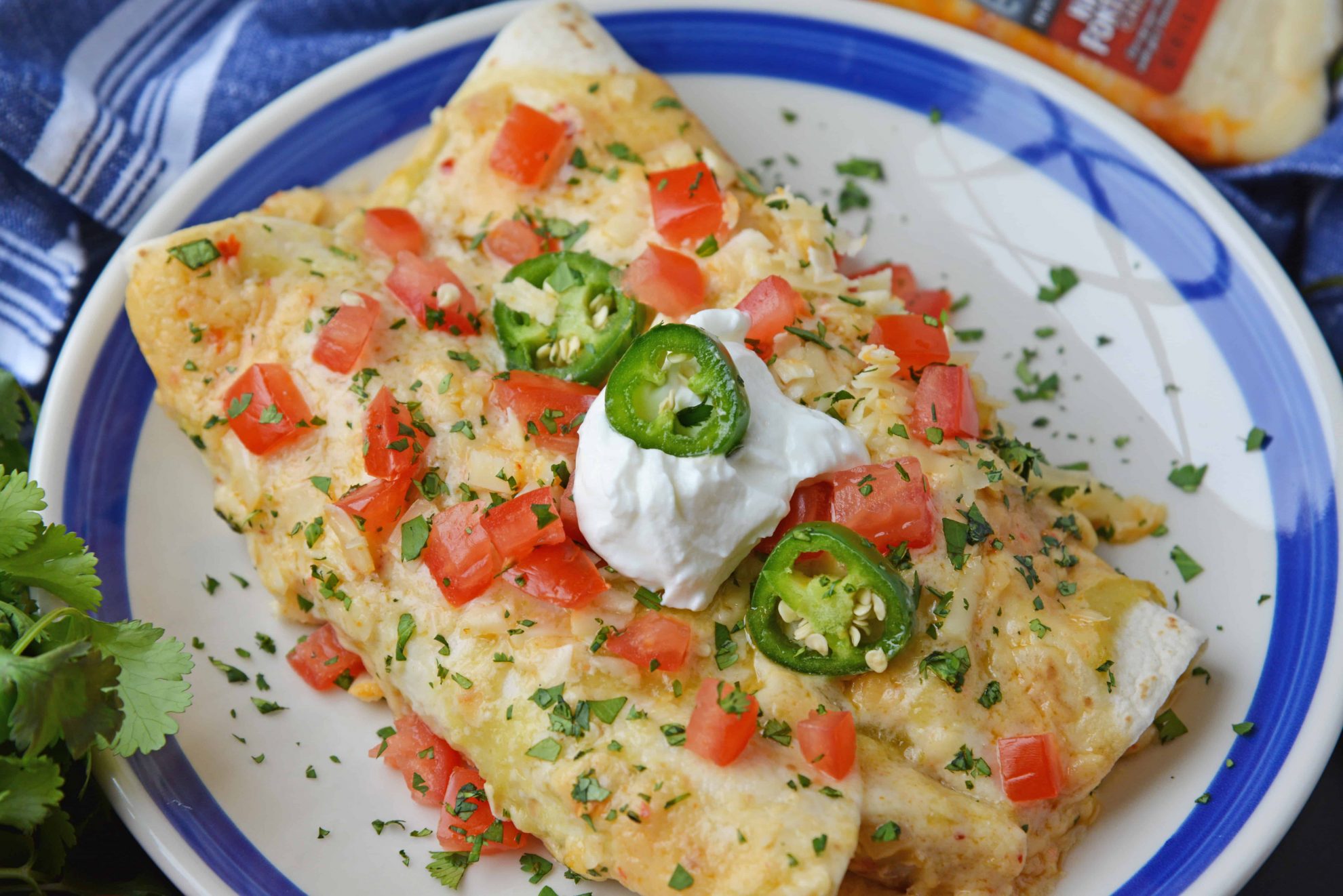 smothered chicken burritos on a serving plate 