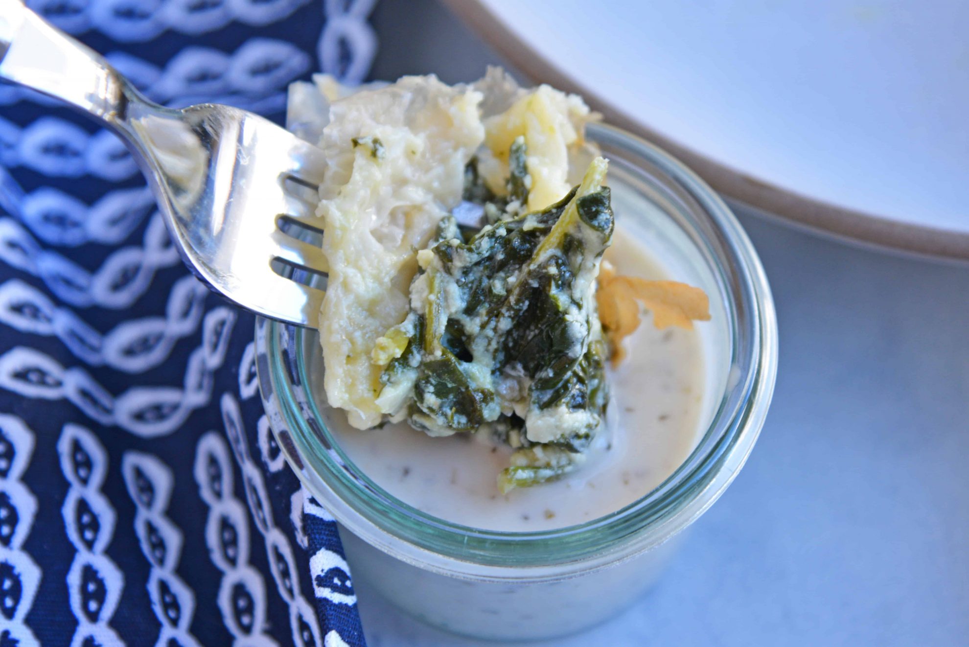 Spanakopita dipping into tzatziki