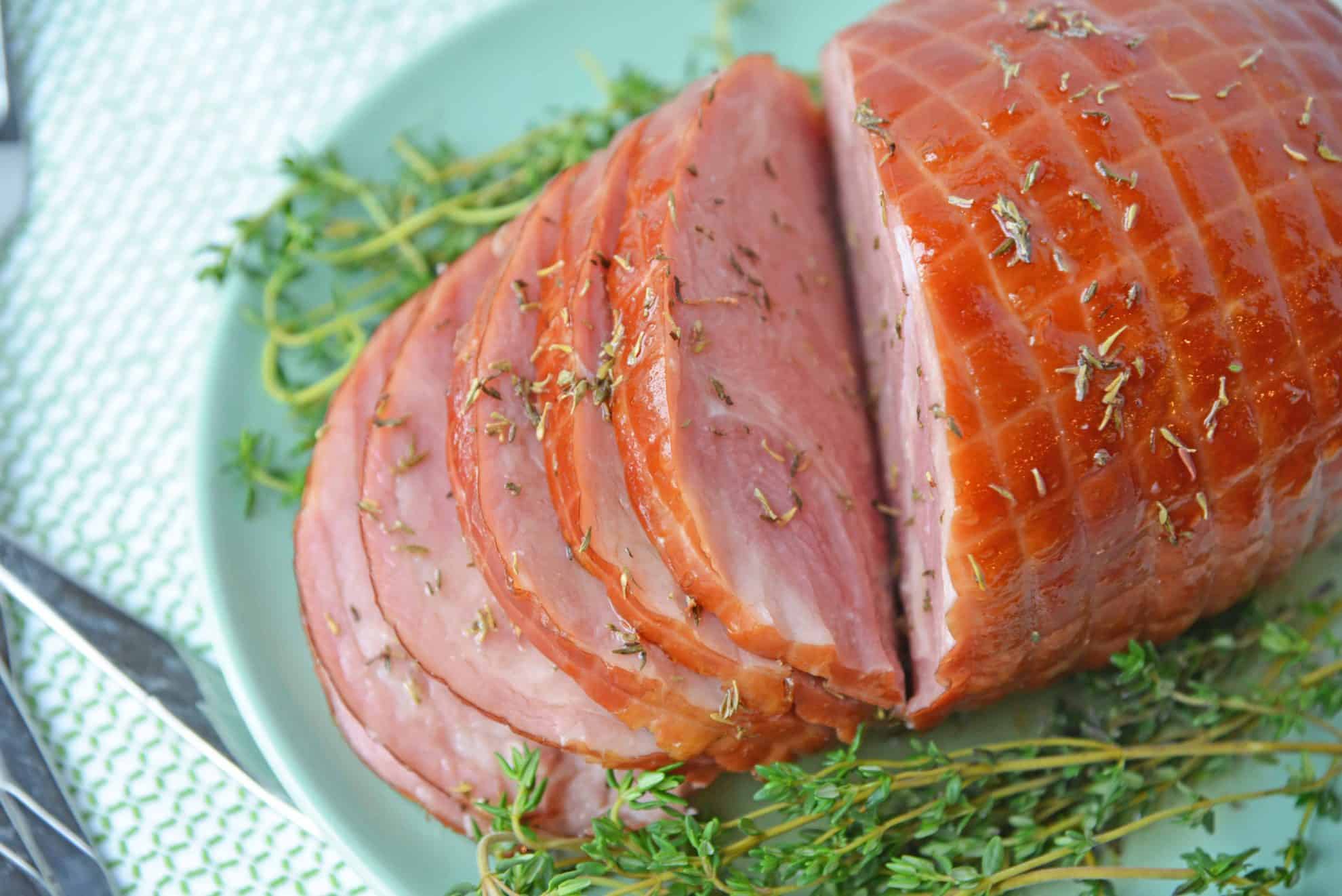 Overhead shot of sliced ham on a green platter 