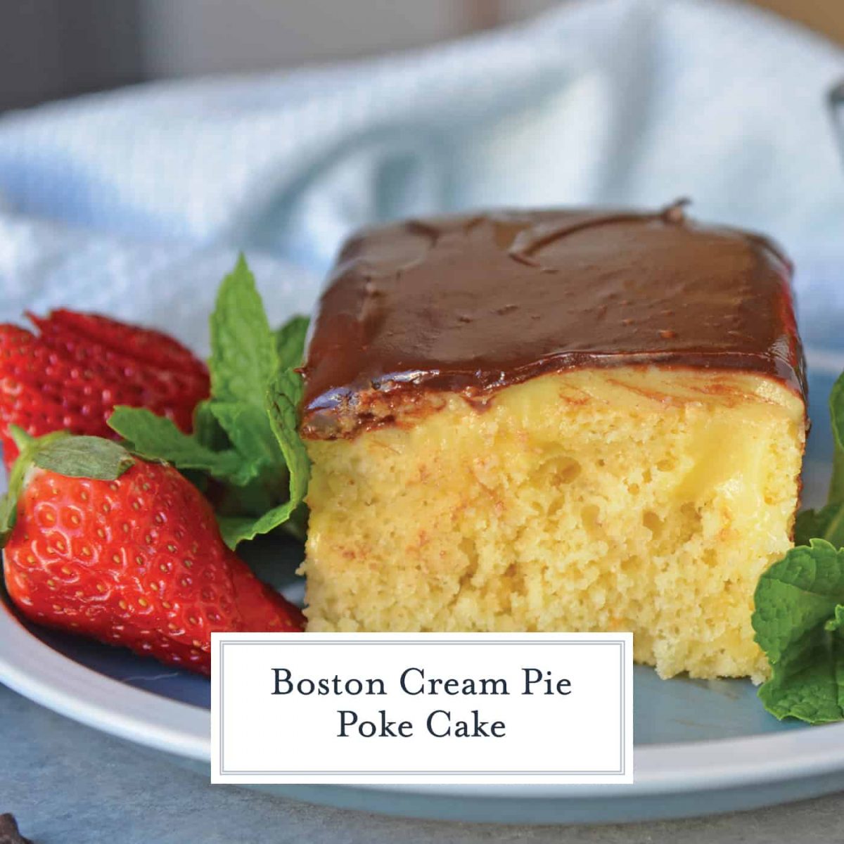 Piece of Boston Cream Poke Cake with strawberry garnish