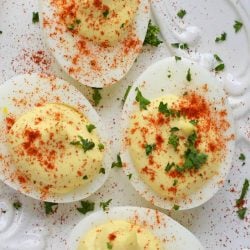 A close up of deviled eggs dusted with paprika