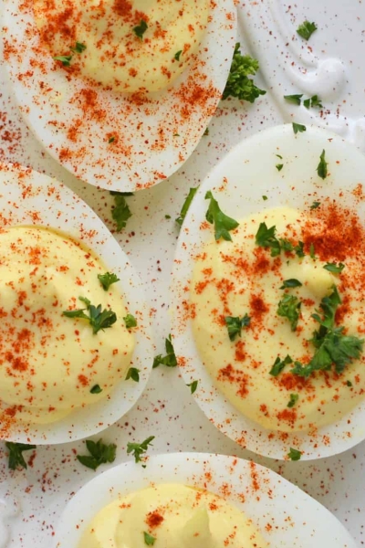 A close up of deviled eggs dusted with paprika
