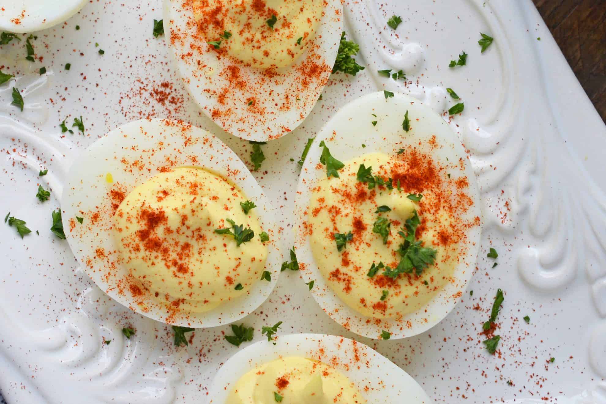 A close up of deviled eggs dusted with paprika 