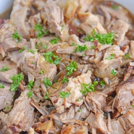 Close up of pulled pork in a honey balsamic sauce in a bowl