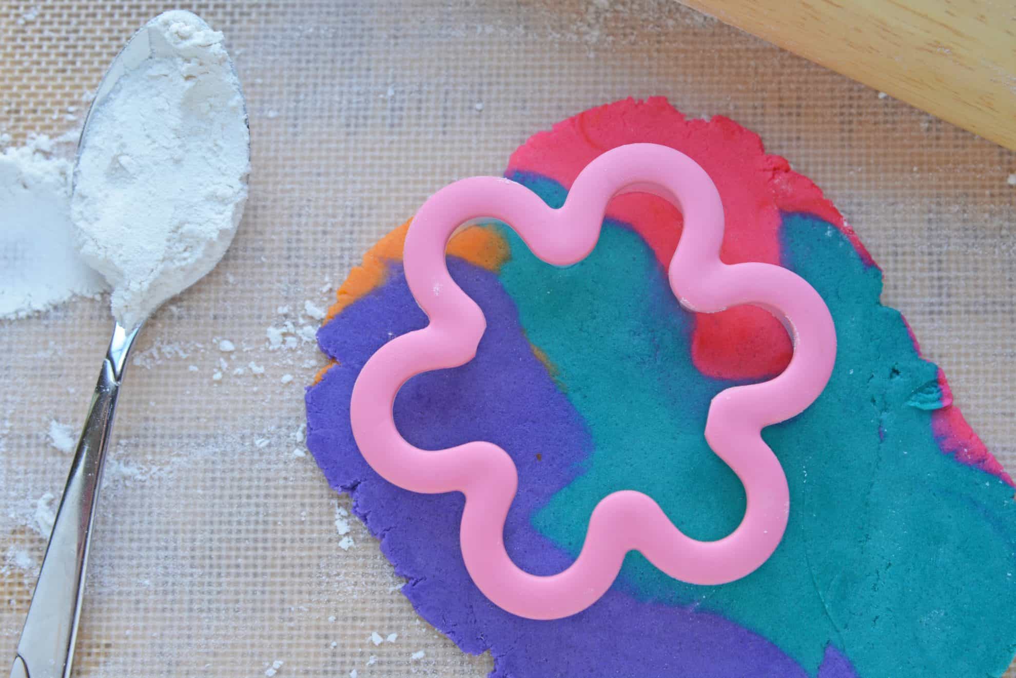 Cutting out a rolled sugar cookie