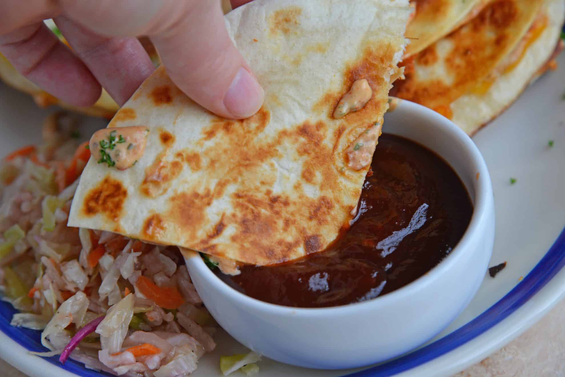 quesadilla dipping into bbq sauce 