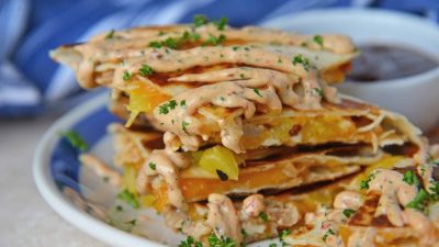 A close up of a plate of food, with Chicken and Quesadilla
