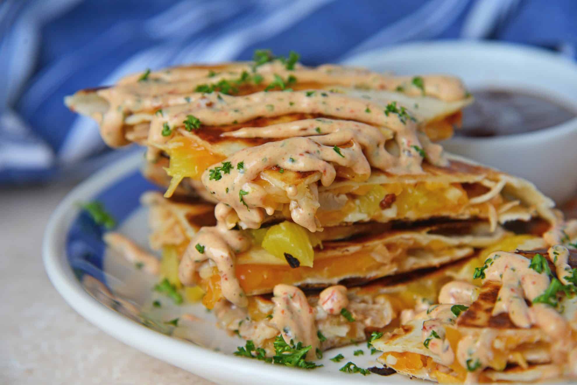 A close up of a plate of food, with Chicken and Quesadilla