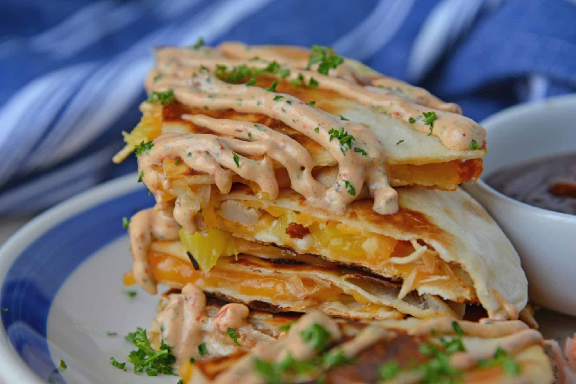 A close up of a sandwich on a plate, with Quesadilla