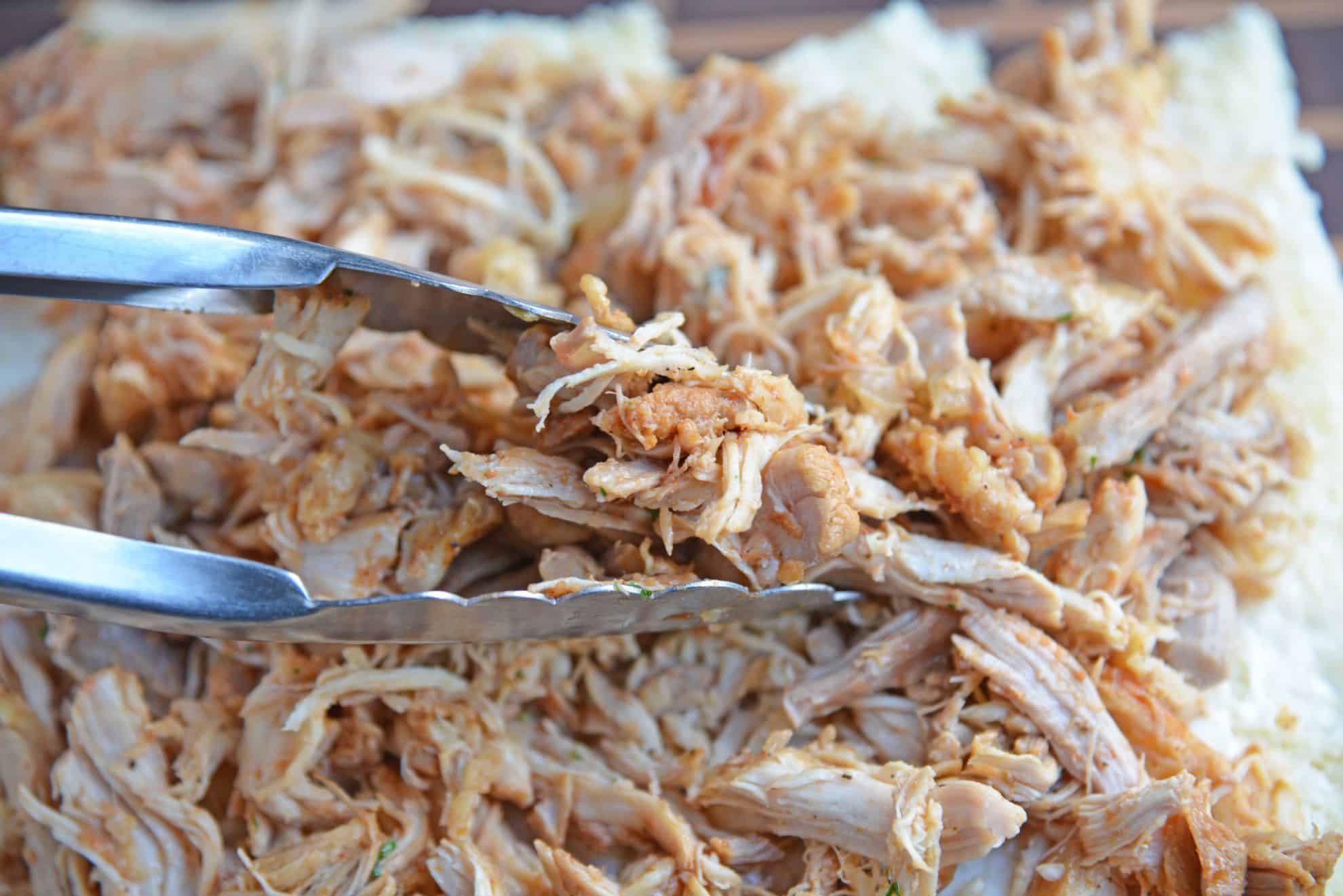 Tongs with shredded chicken