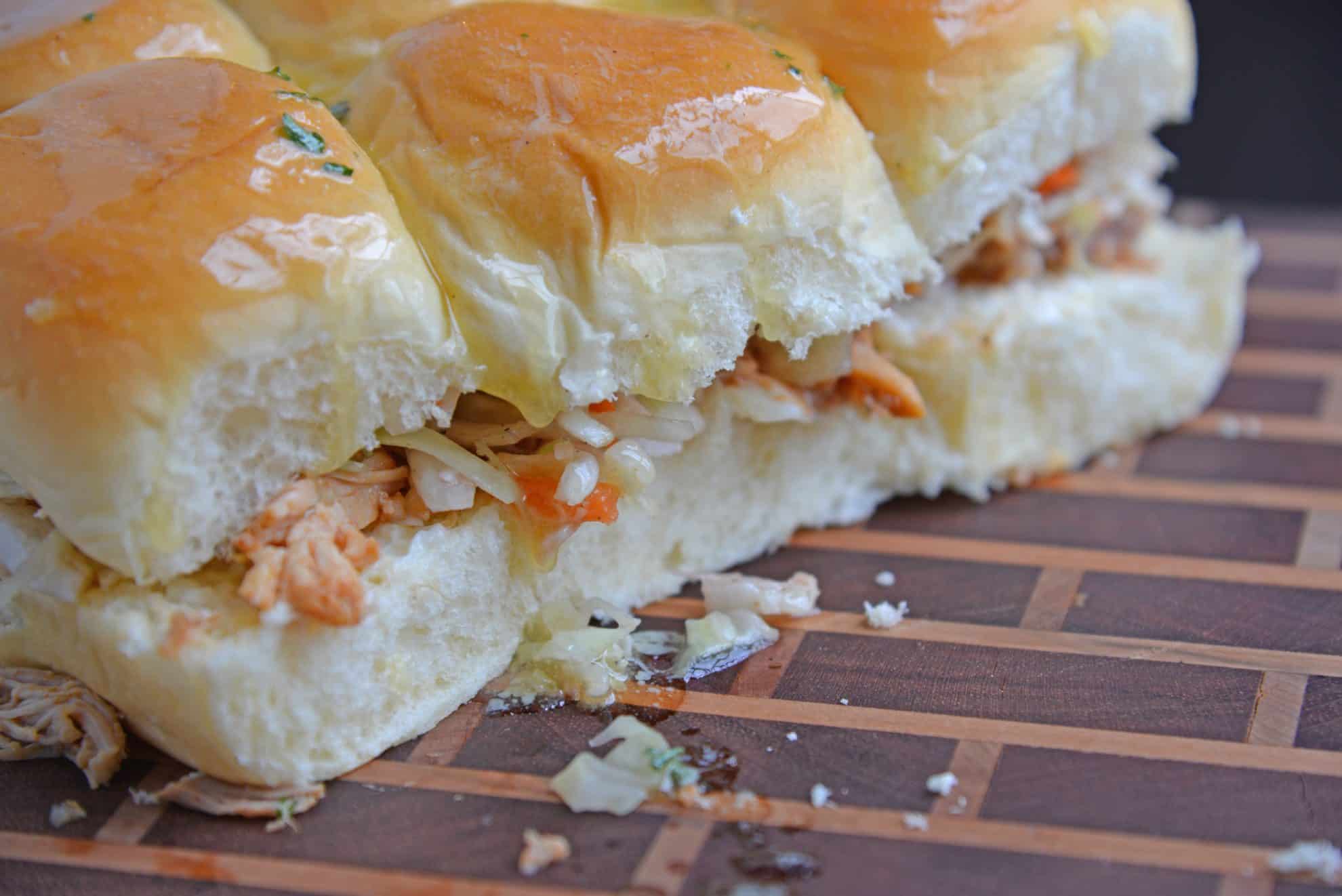 Close up of BBQ chicken sliders with slaw on a cutting board