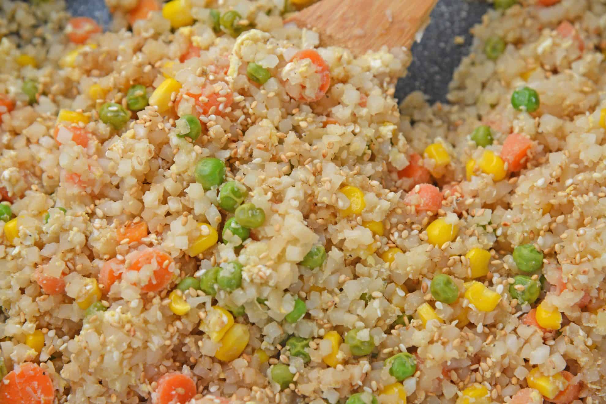 A close up of a plate of food with rice and vegetables, with Cauliflower and Fried rice