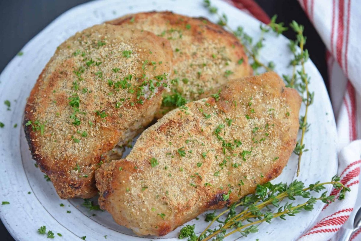 Crispy baked pork chops on a white plate
