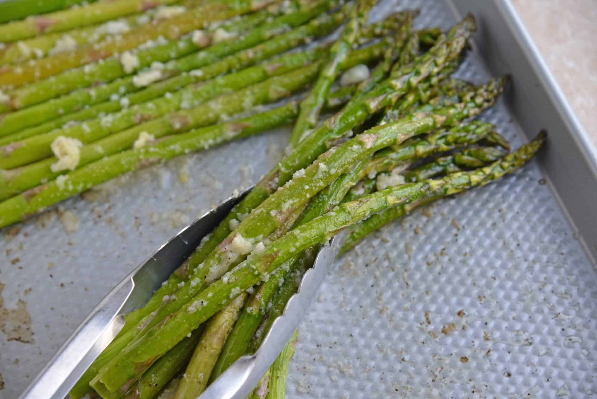 asparagus being picked up with a spatula 