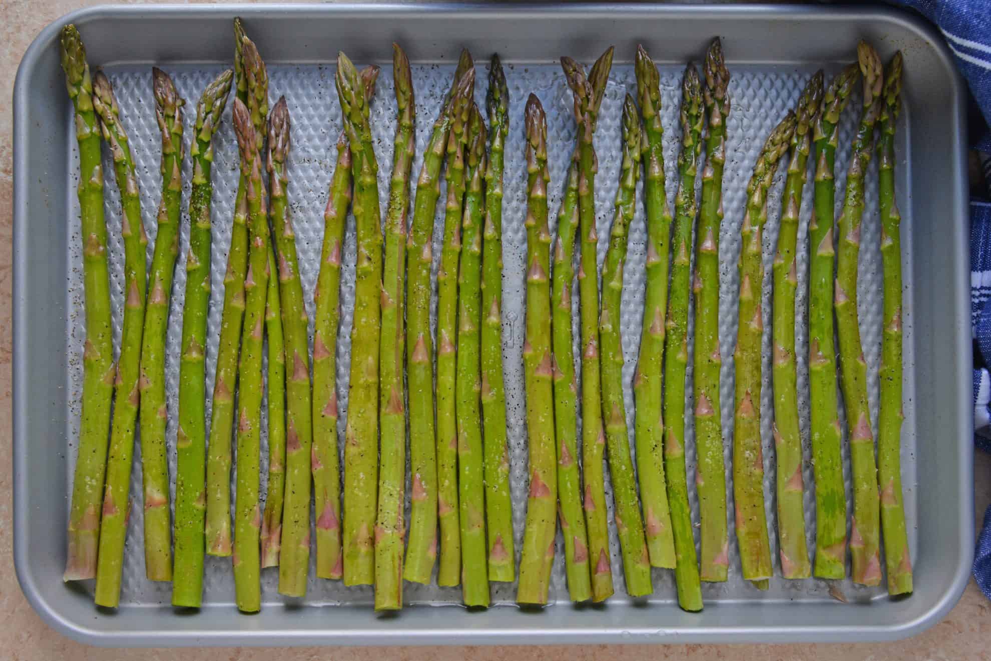 asparagus on a rimmed baking sheet 