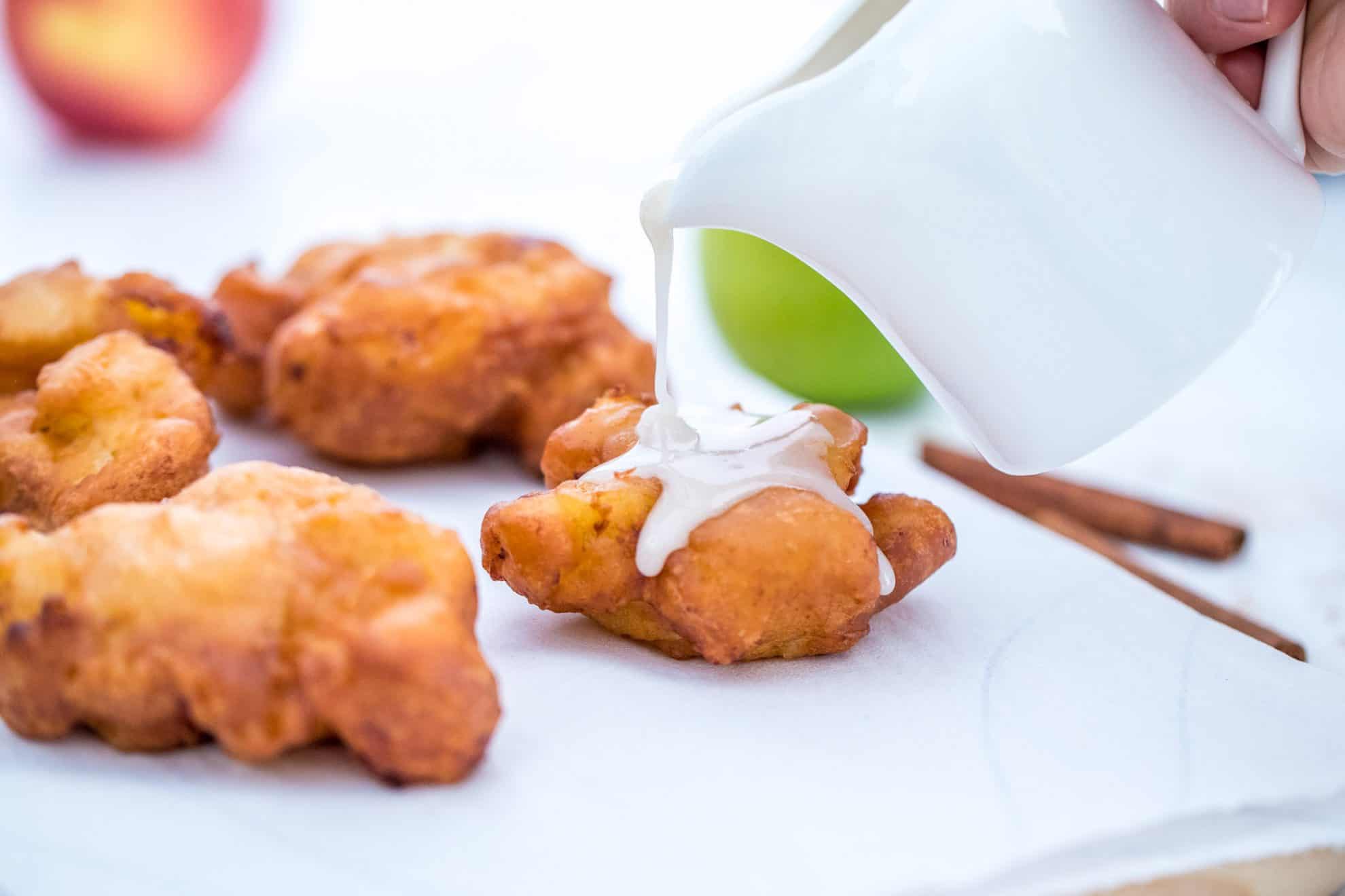 Icing pouring on homemade apple fritters