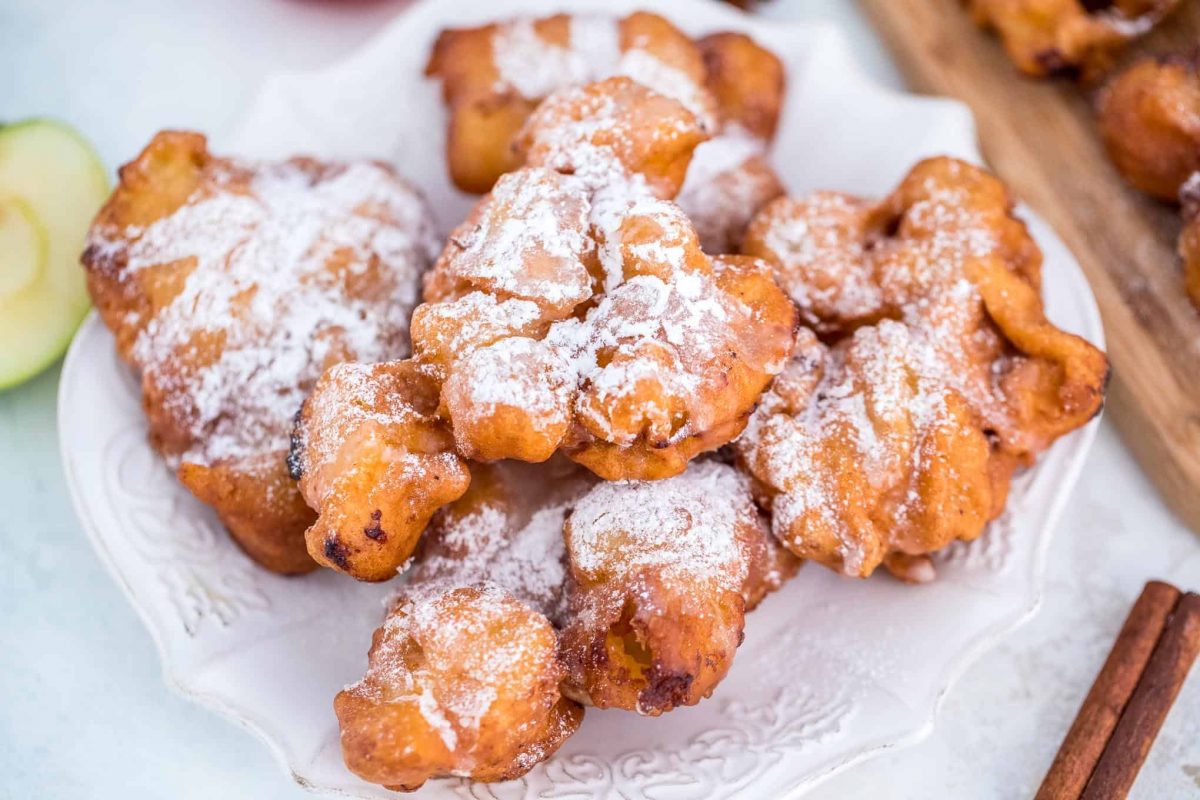 Crispy apple fritters on a white serving dish
