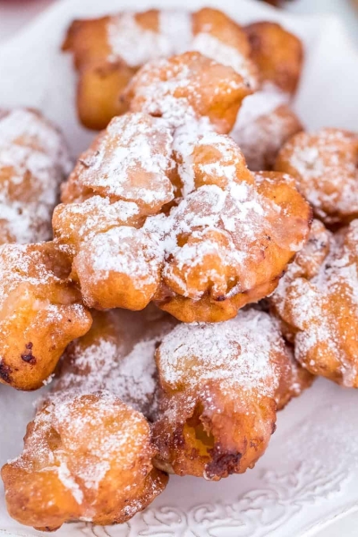 Crispy apple fritters on a white serving dish