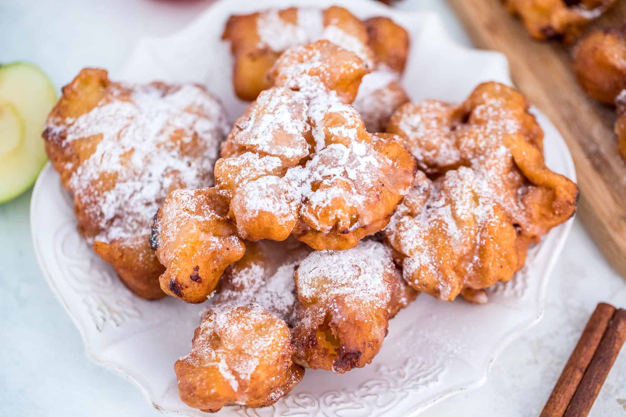 Crispy apple fritters on a white serving dish
