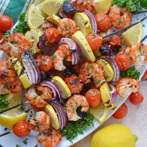 Overhead of garlic shrimp kabobs on a serving platter