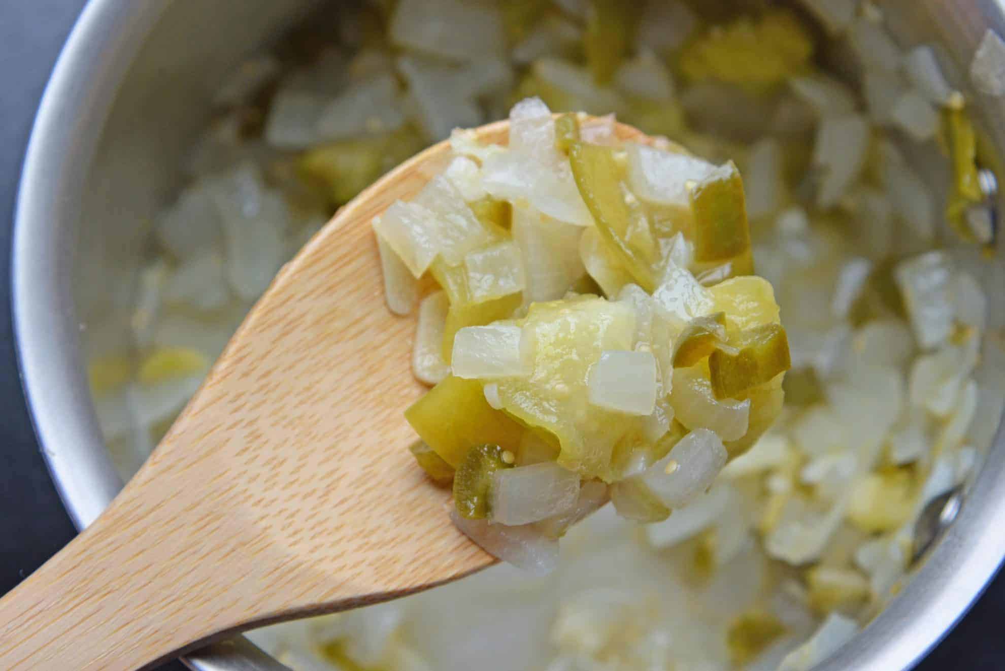 homemade enchilada sauce ingredients on a wooden spoon