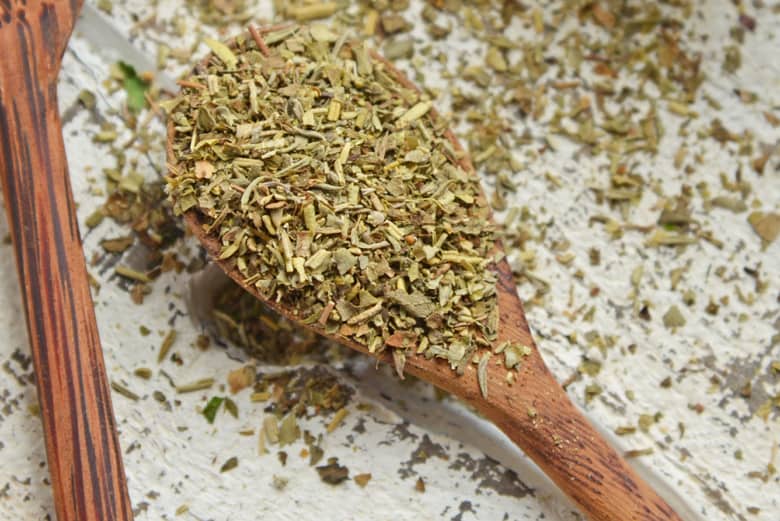 close up of italian spices in a wooden spoon