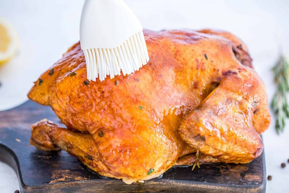 brined chicken being basted after roasting 