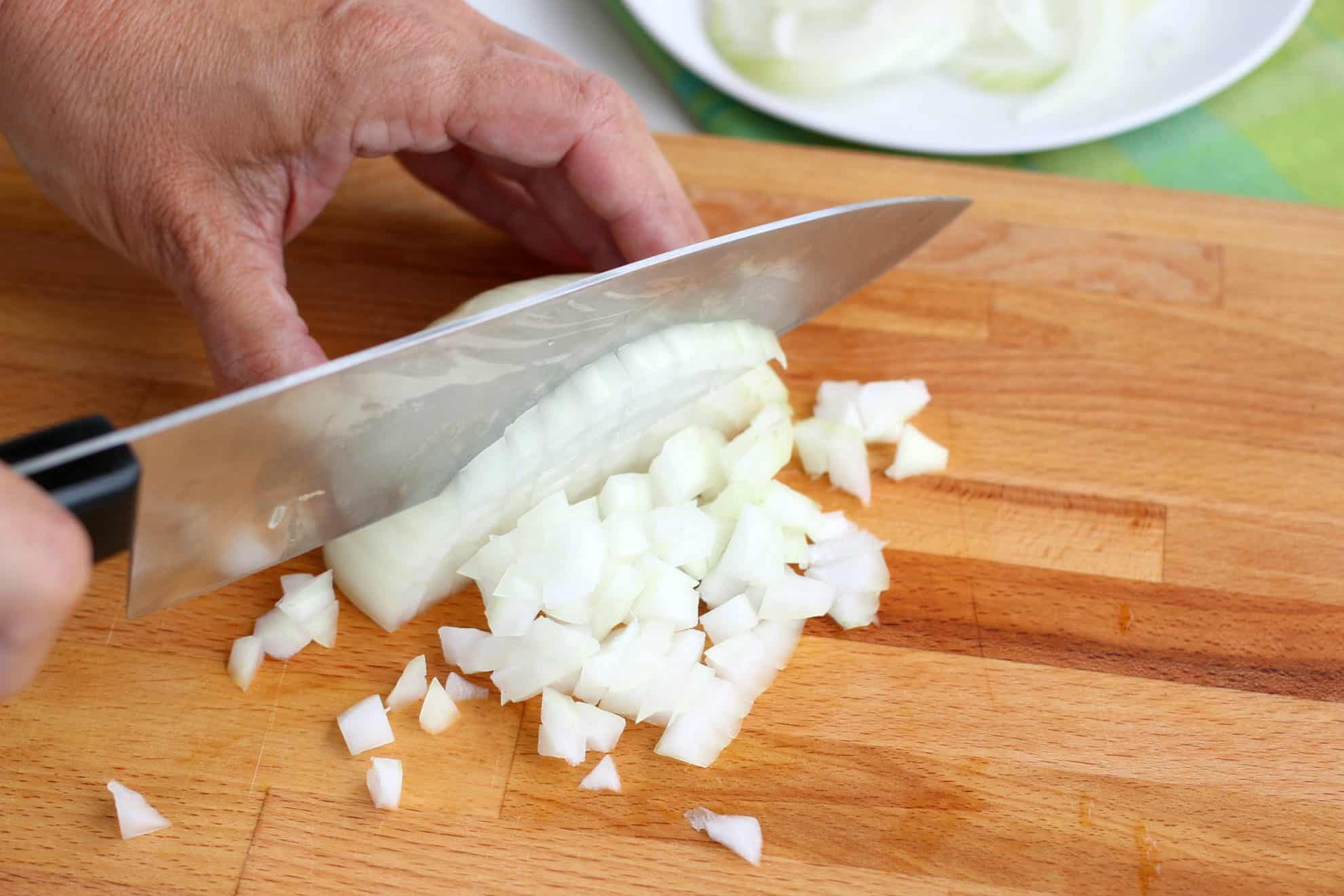 Slicing an onion in preparation of dicing.