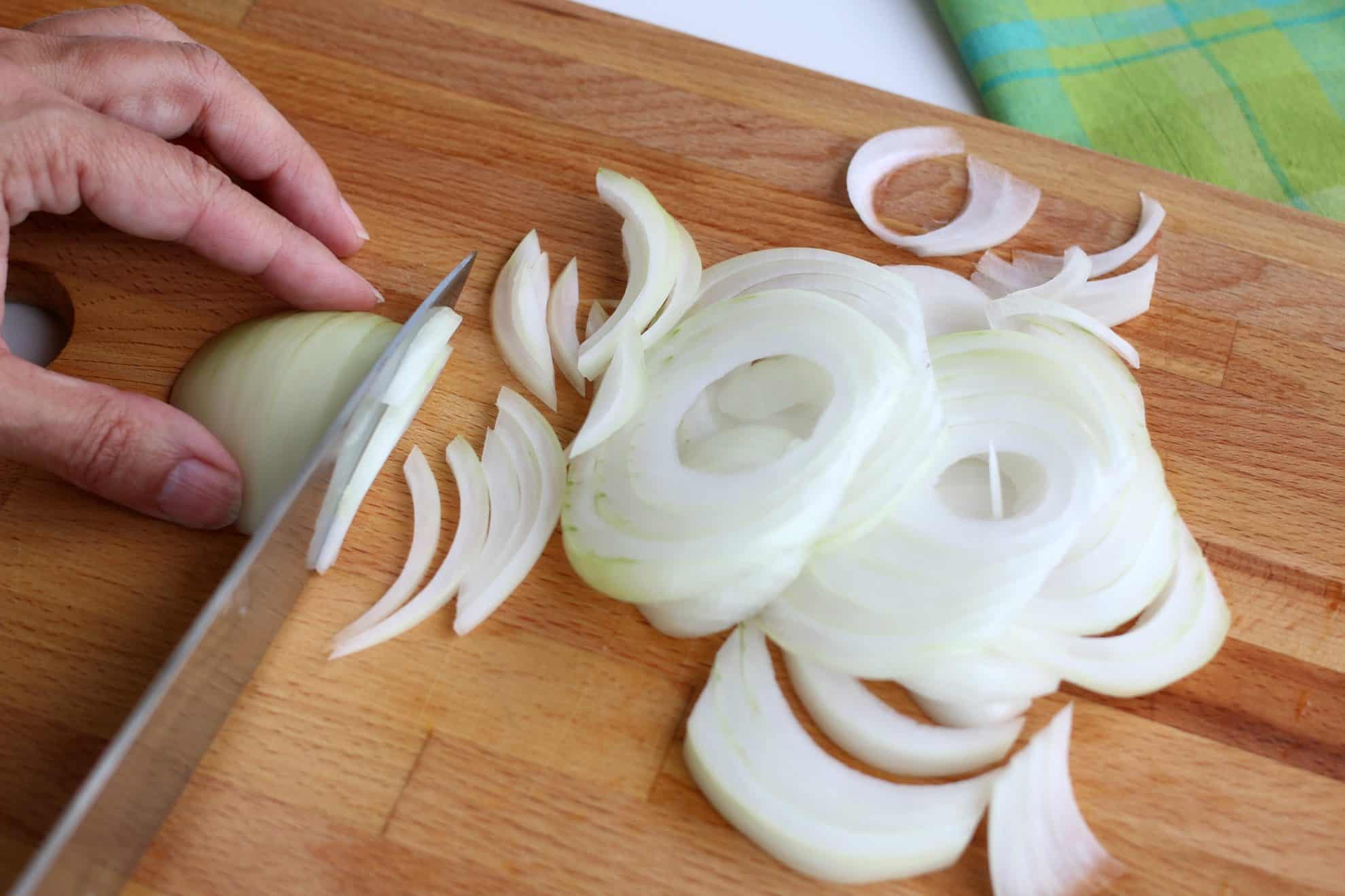 Slicing an onion in preparation of dicing.