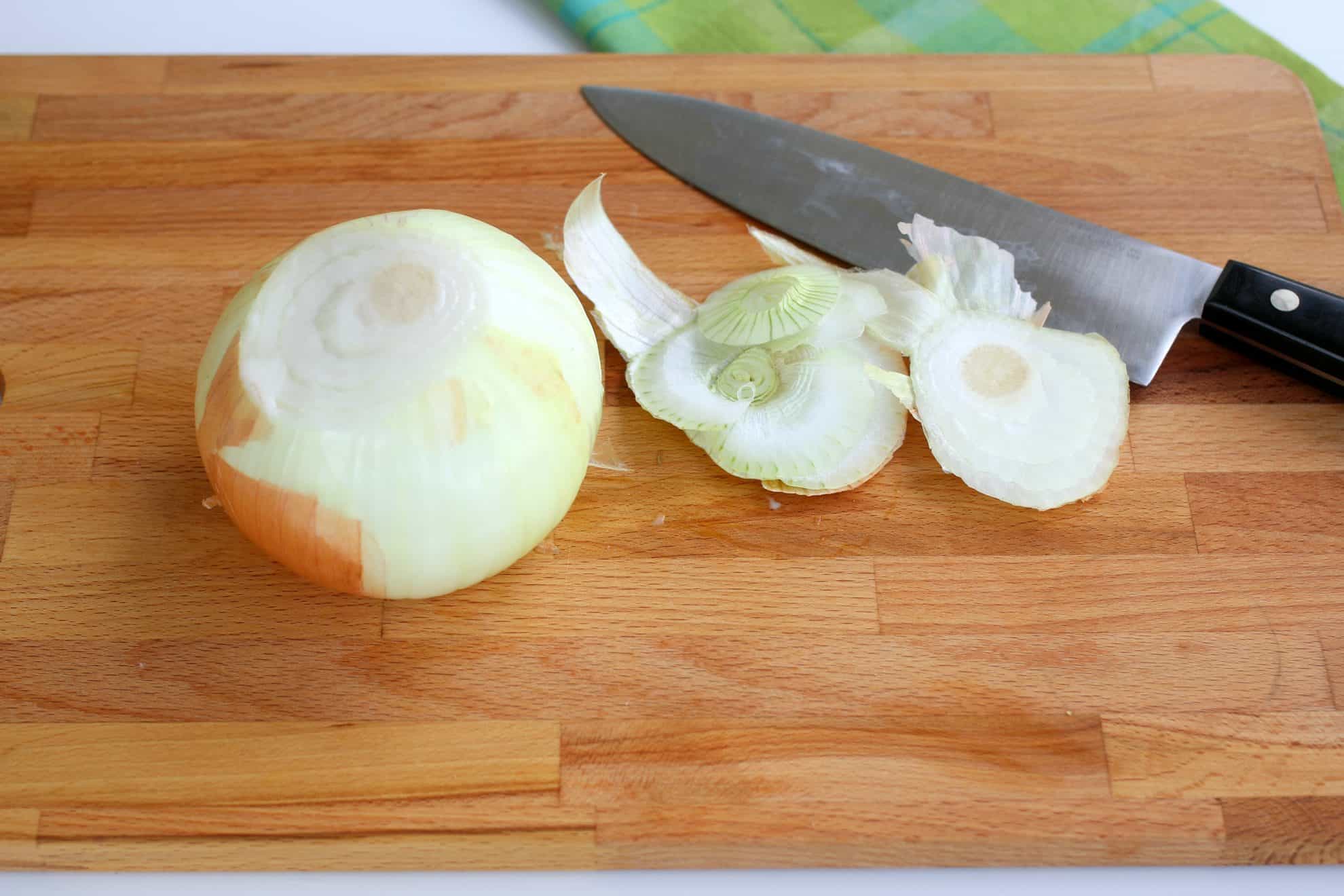 Slicing the ends off of an onion.