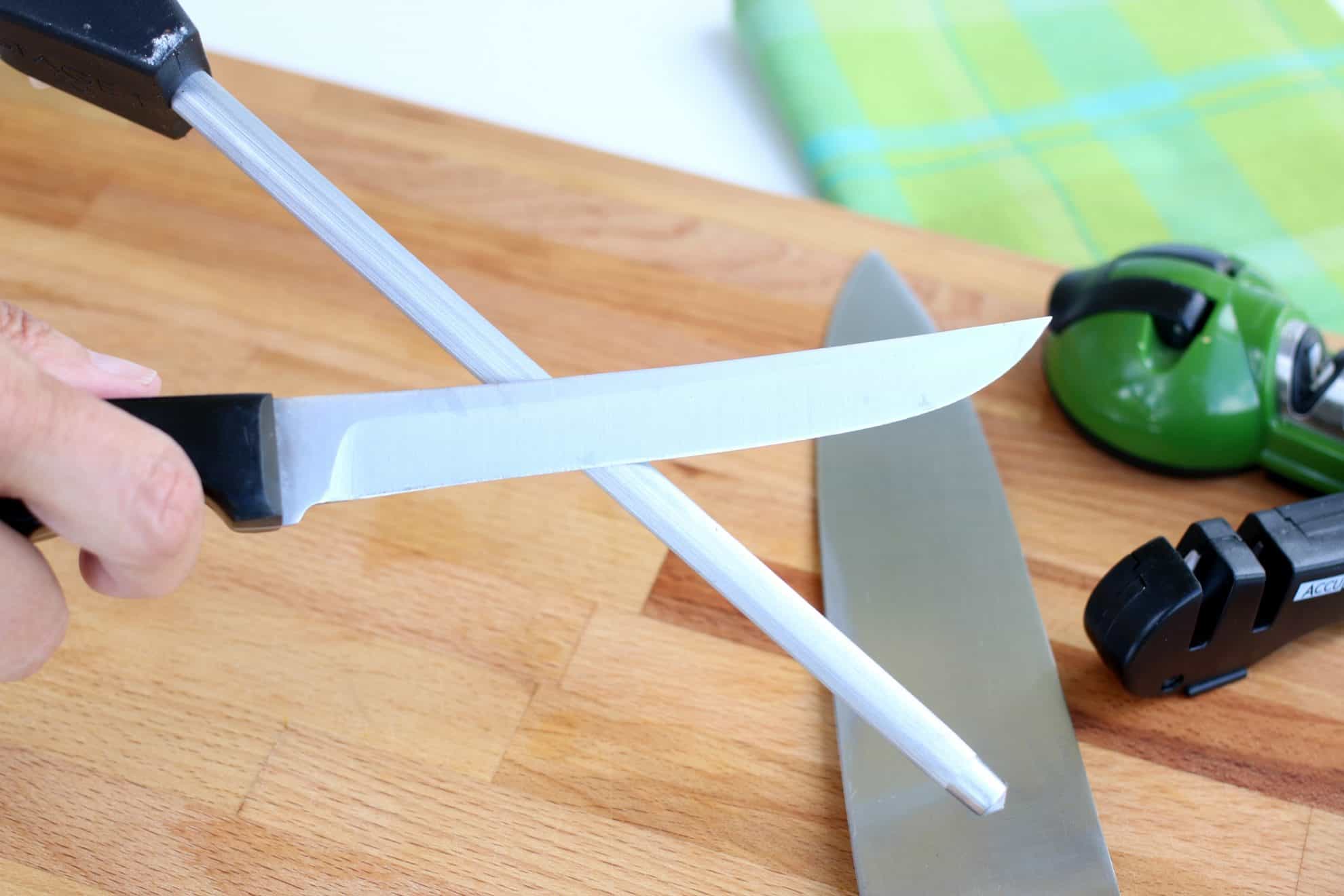 Sharpening a kitchen knife using a honing steel.