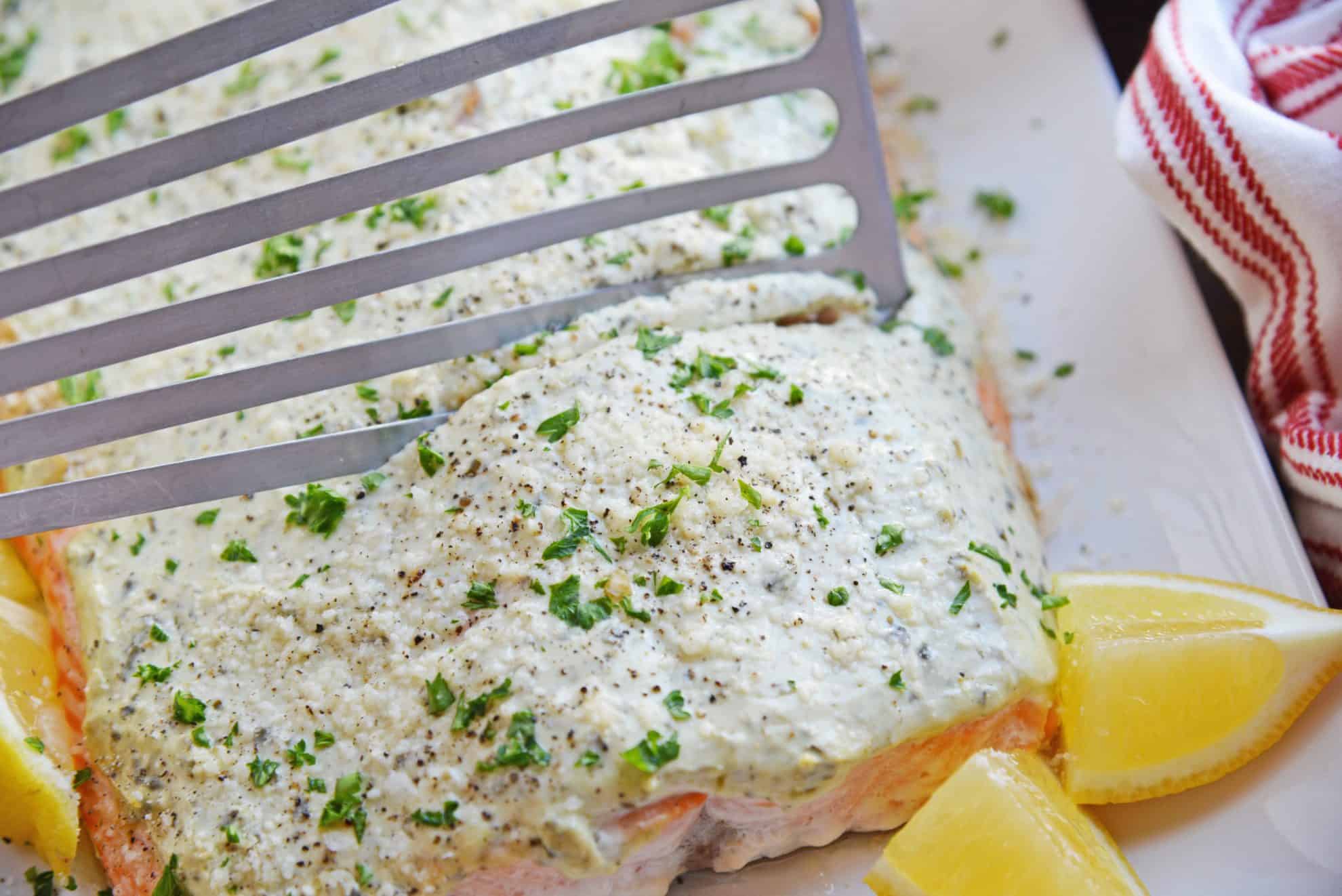 Spatula cutting into baked salmon