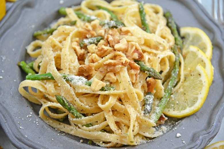 A dish is filled with pasta and asparagus