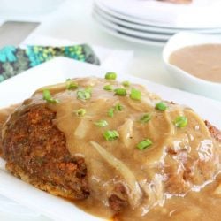 A close up of food on a plate, with Meatloaf and Onion