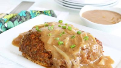 A close up of food on a plate, with Meatloaf and Onion