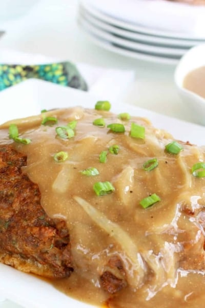 A close up of food on a plate, with Meatloaf and Onion